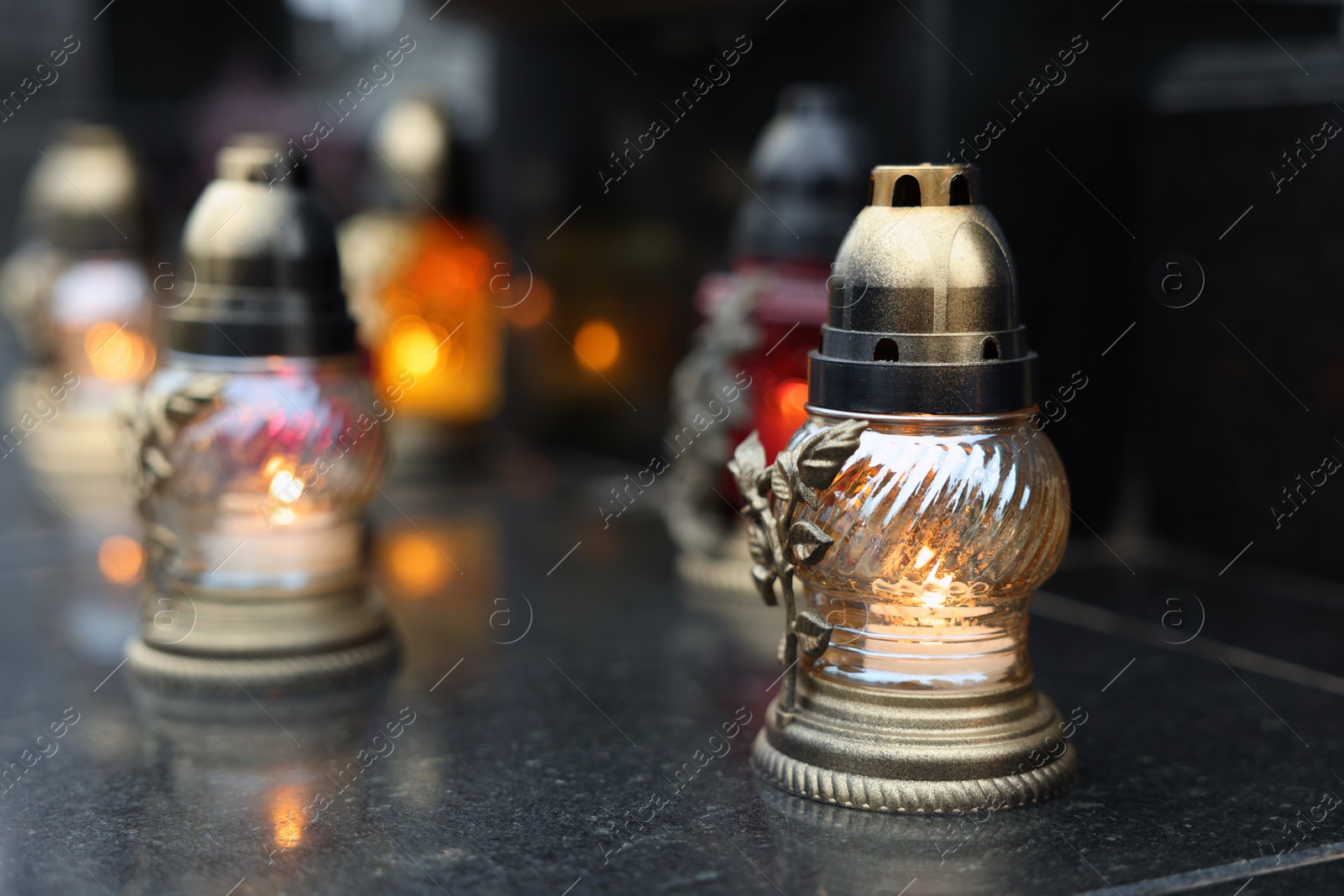 Photo of Grave lights on granite surface at cemetery