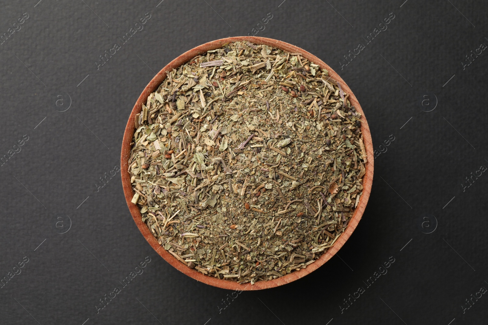 Photo of Bowl with dried thyme on grey background, top view