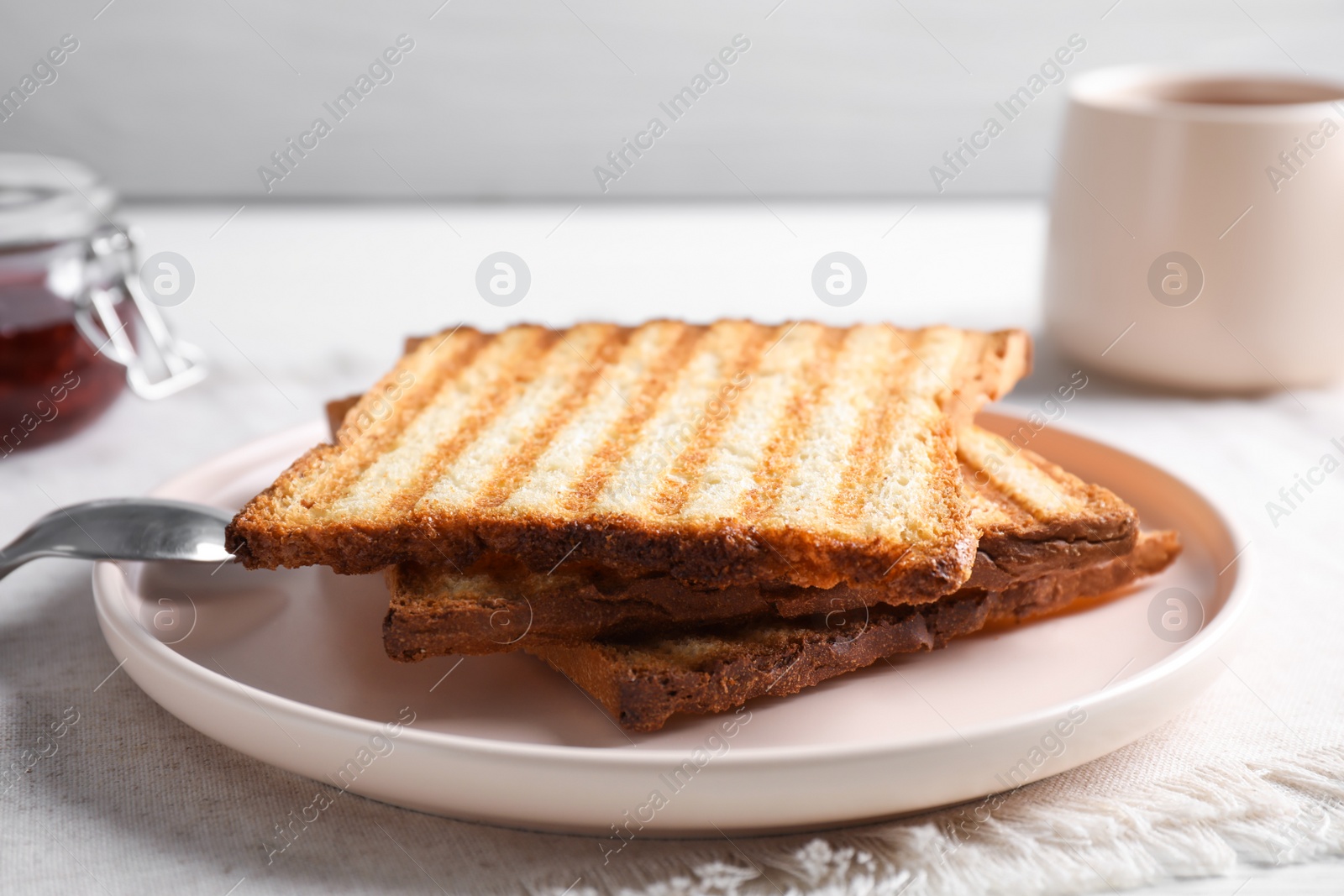 Photo of Tasty toasts served for breakfast on table, closeup