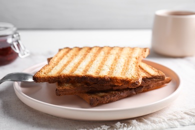 Photo of Tasty toasts served for breakfast on table, closeup