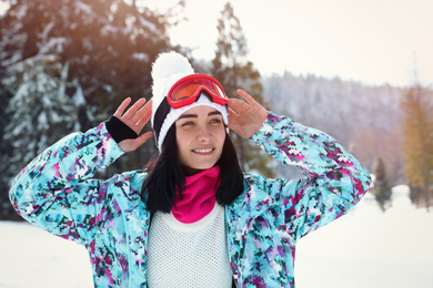 Photo of Young woman at mountain resort. Winter vacation