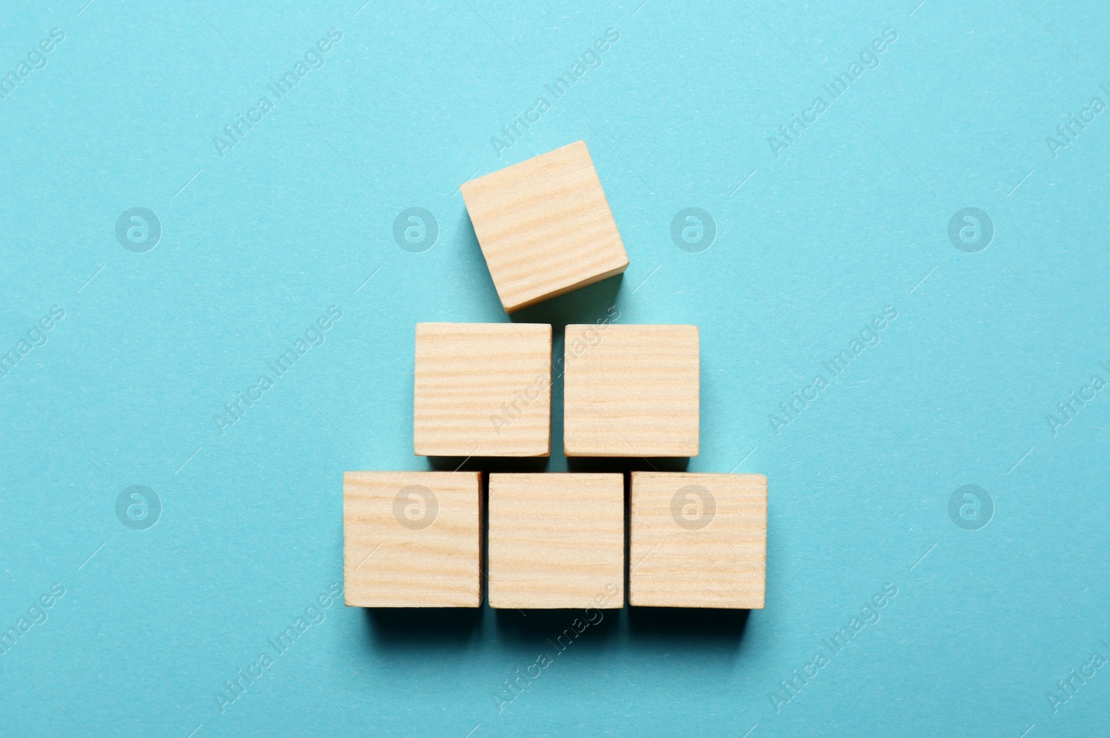 Photo of Blank cubes on light blue background, flat lay with space for text. Idea concept