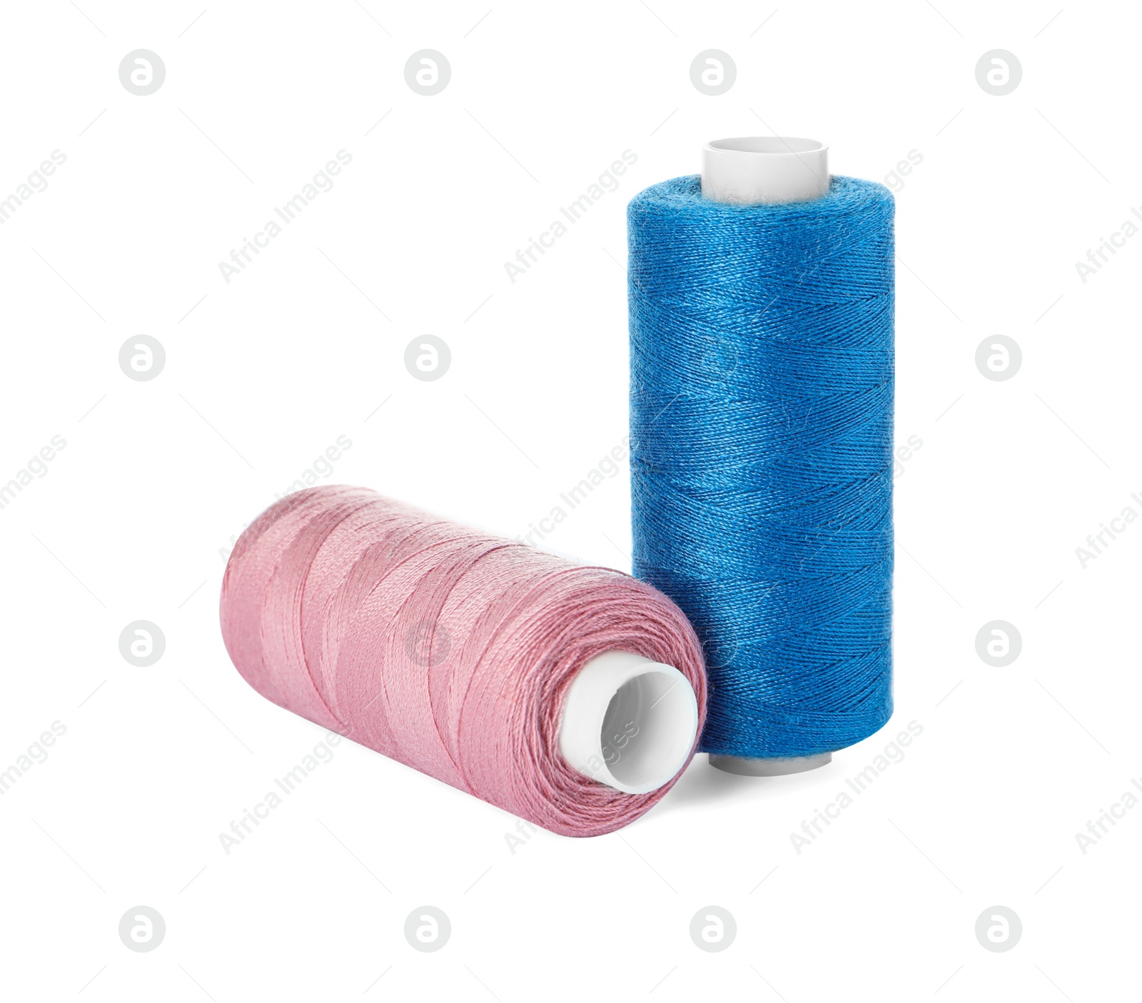 Photo of Different colorful sewing threads on white background