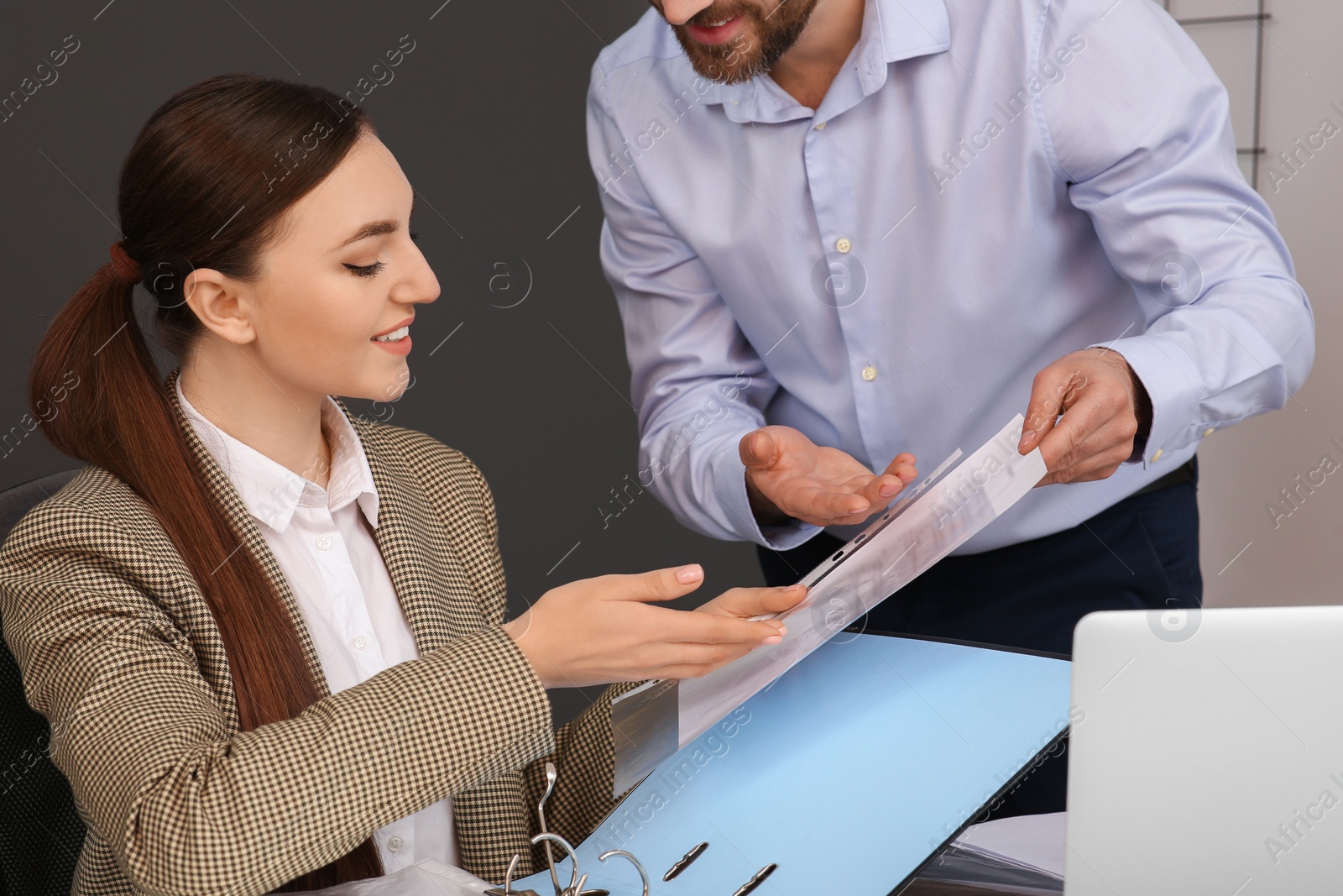 Photo of Businesspeople working together with documents in office