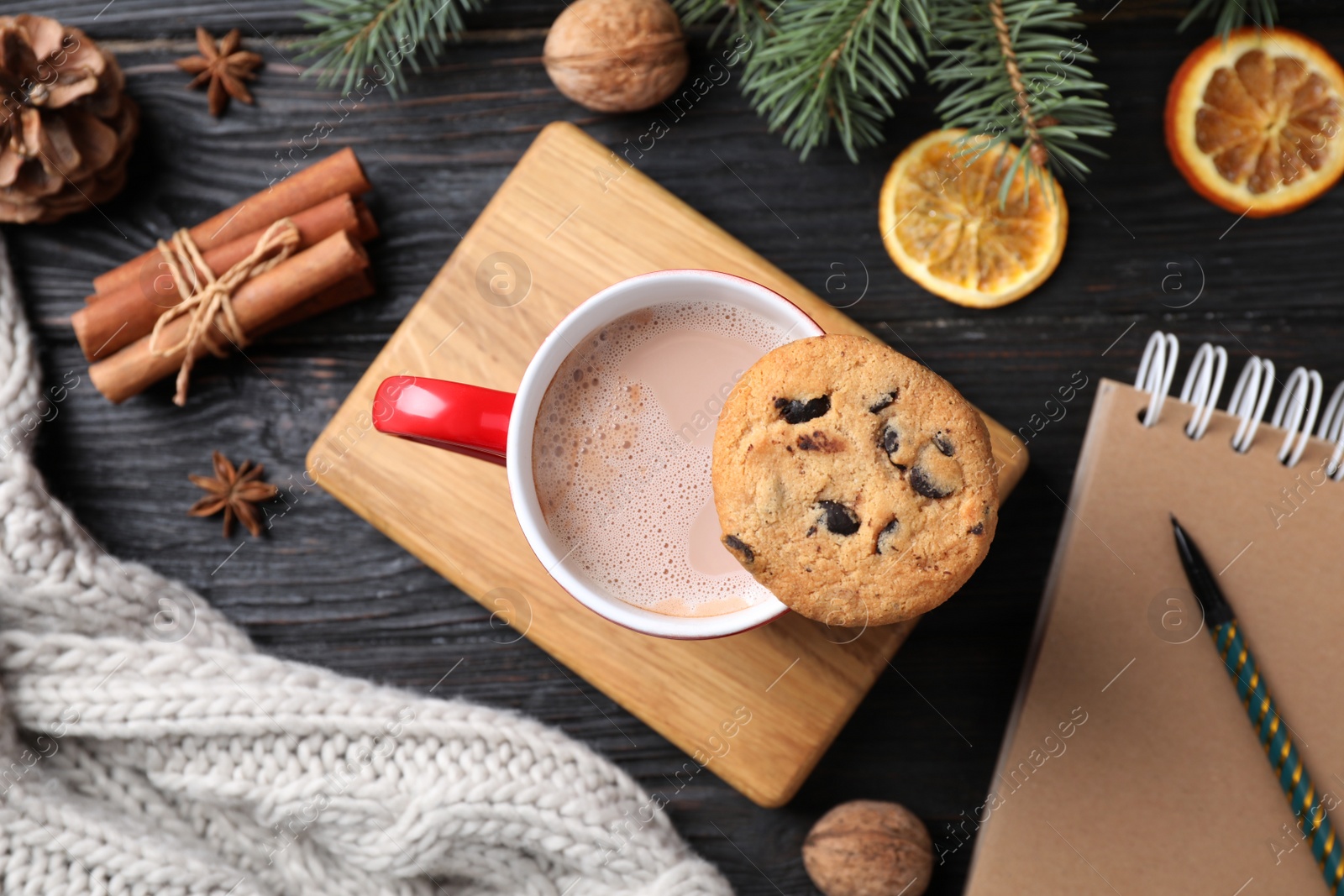 Photo of Flat lay composition with cup of tasty cocoa and cookie on black wooden table