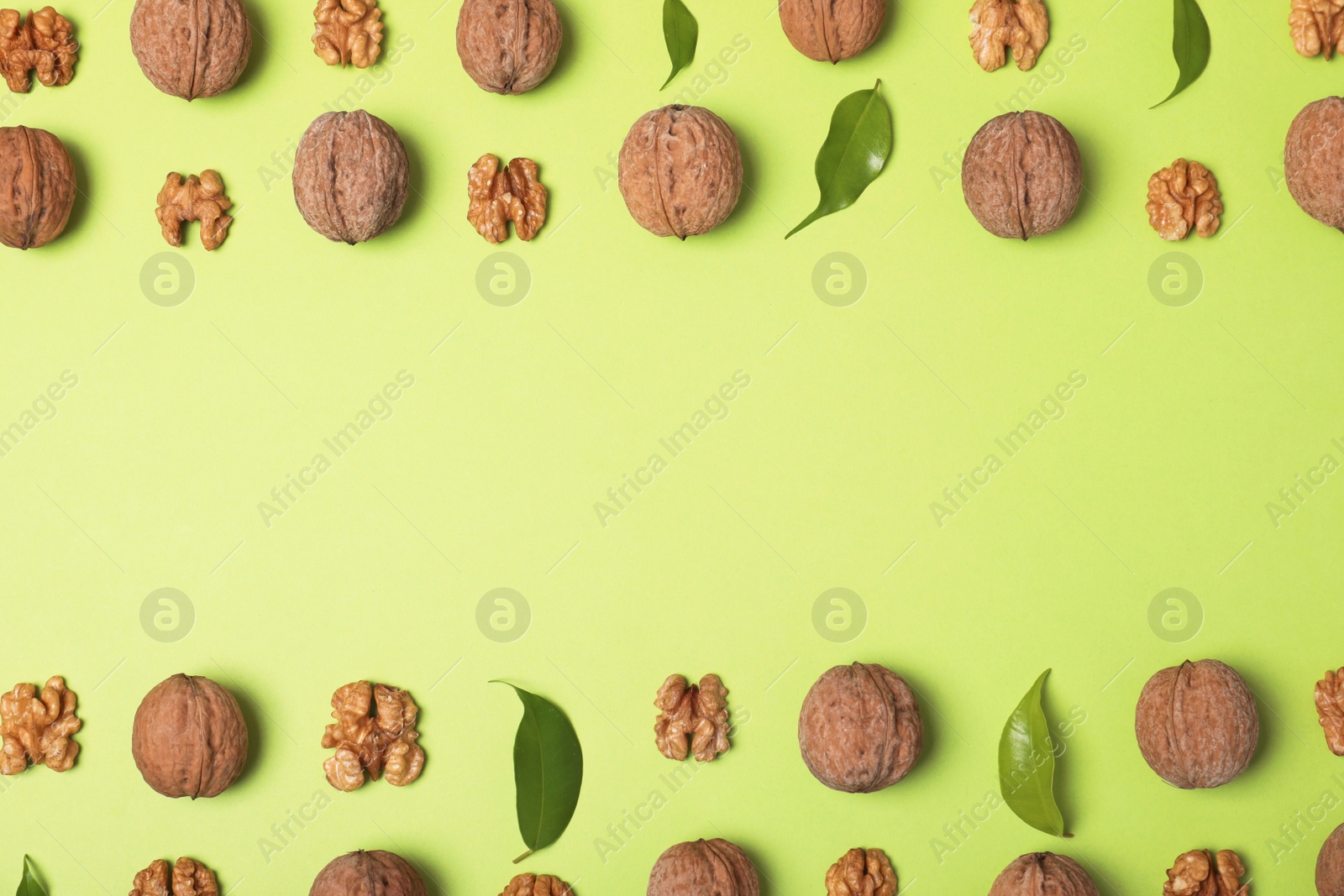 Photo of Group of walnuts on color background, flat lay with space for text