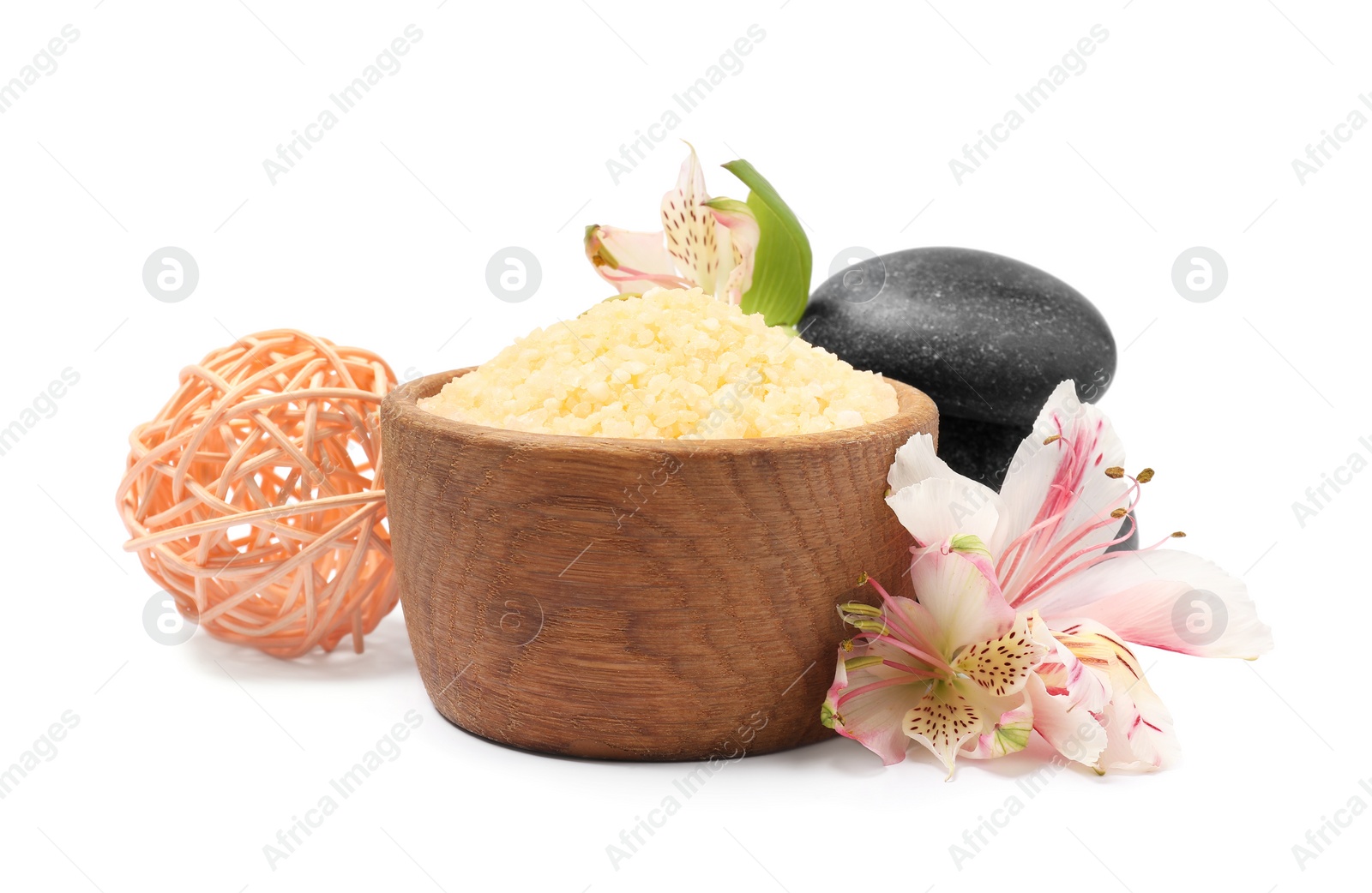 Photo of Orange sea salt in bowl, spa stones, rattan ball and floral decor isolated on white