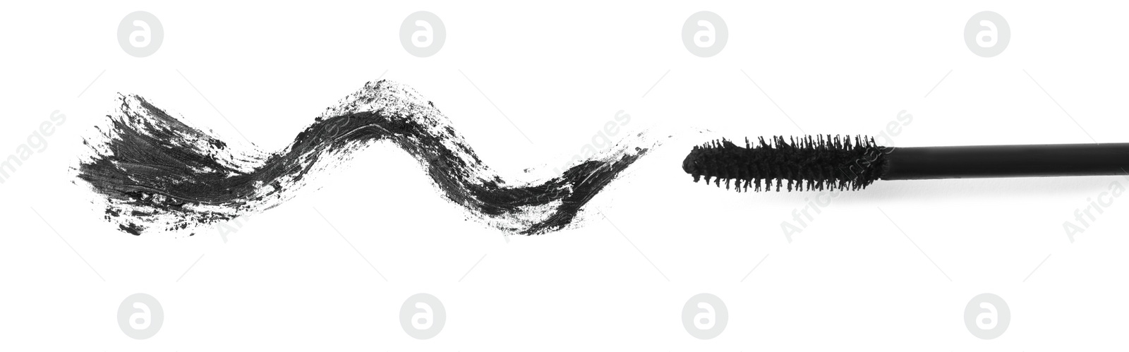 Photo of Applicator and black mascara smear for eyelashes on white background, top view