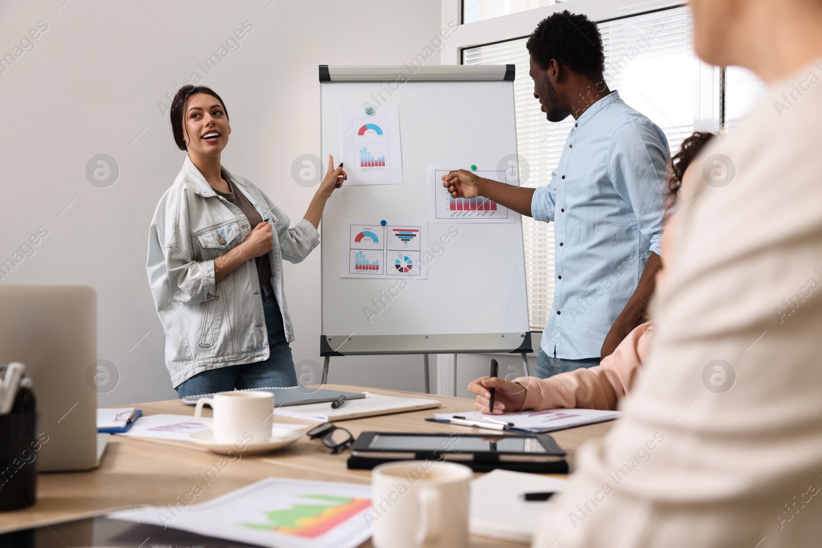 Photo of Team of employees working together in office. Startup project