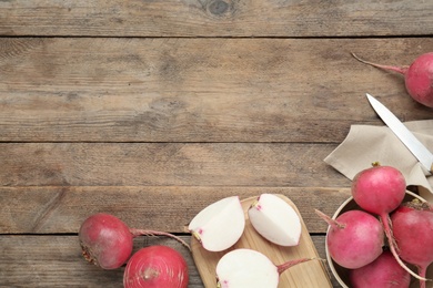 Photo of Raw red turnips on wooden table, flat lay. Space for text