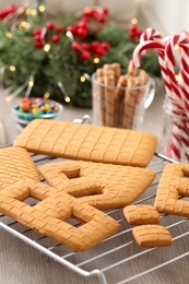 Photo of Parts of gingerbread house on wooden table, closeup