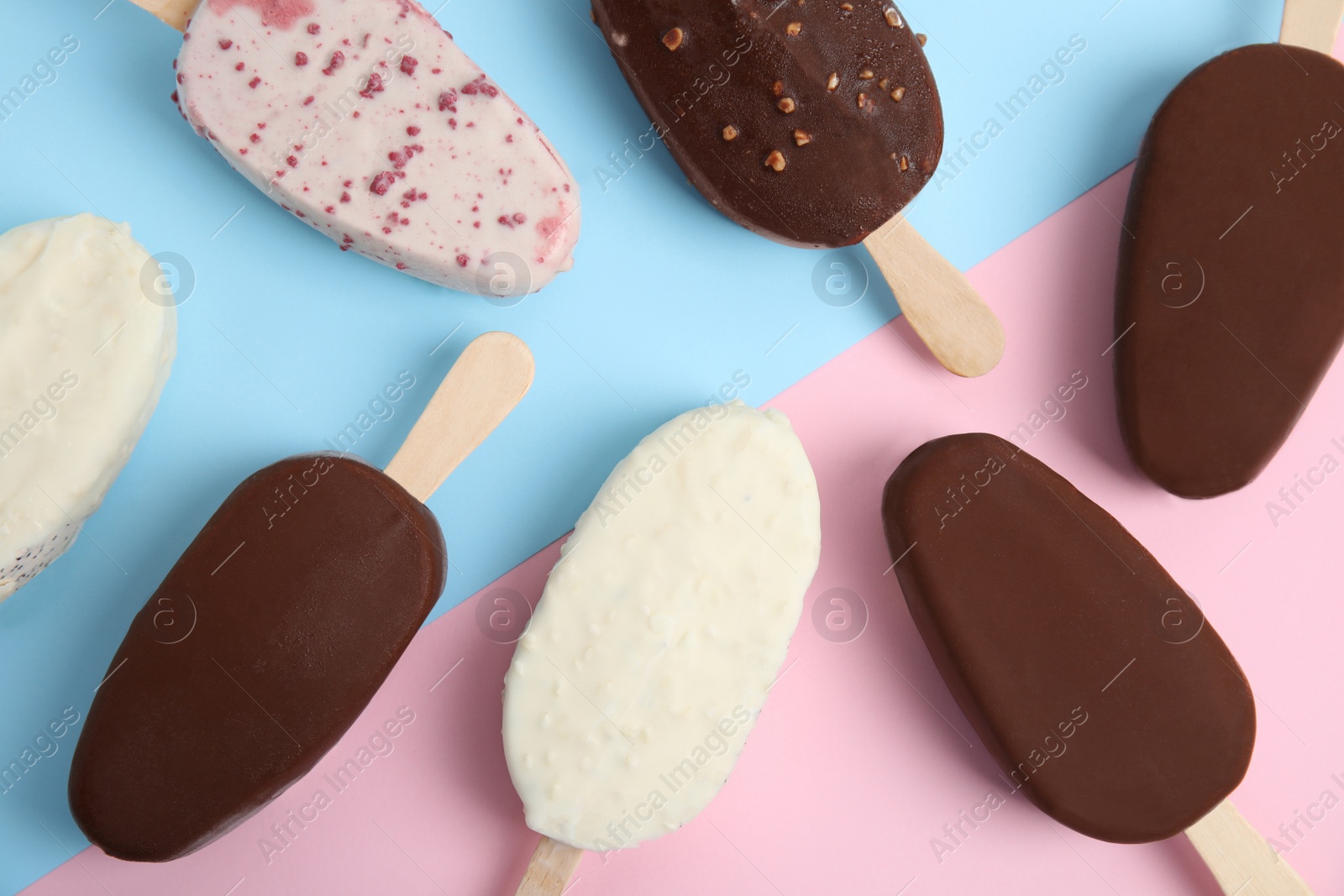 Photo of Glazed ice cream bars on color background, flat lay