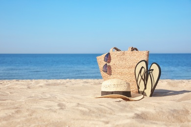 Stylish beach accessories on sandy sea shore