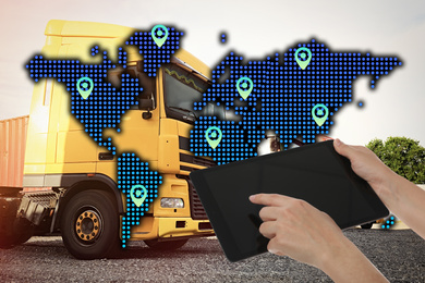 Image of Logistics concept. Woman using tablet against world map illustration and truck