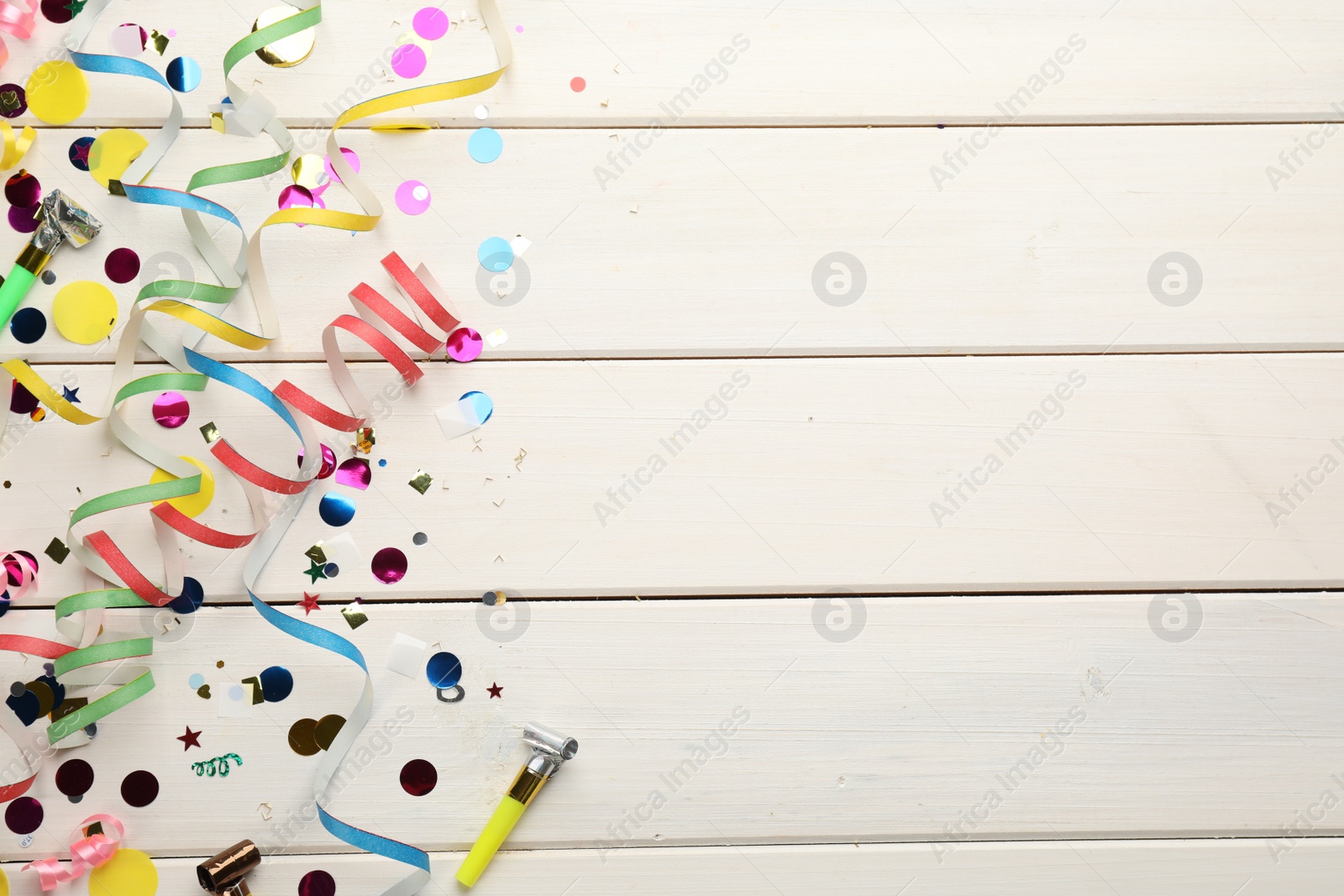 Photo of Flat lay composition with carnival items on white wooden background. Space for text