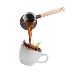 Pouring freshly brewed aromatic coffee from turkish pot into cup. Objects in air on white background