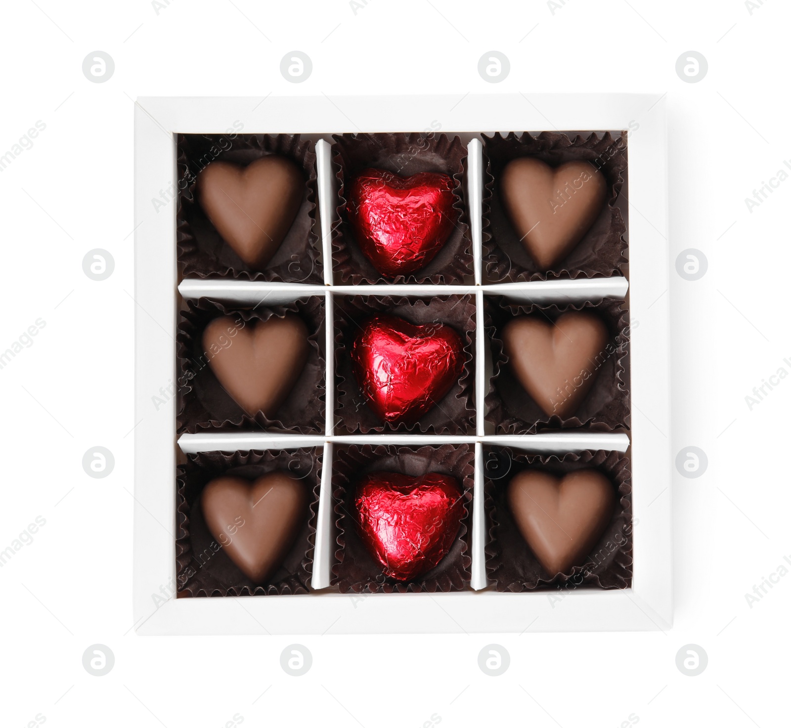 Photo of Tasty heart shaped chocolate candies in box isolated on white, top view. Valentine's day celebration