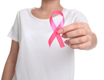 Woman holding pink ribbon on white background, closeup. Breast cancer awareness