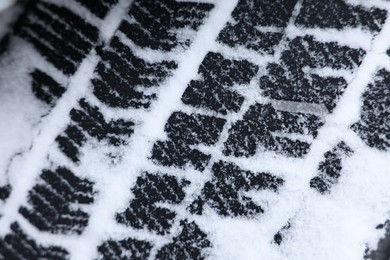 Winter tire covered with snow, closeup view