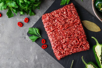 Photo of Flat lay composition with fresh raw minced meat on grey table