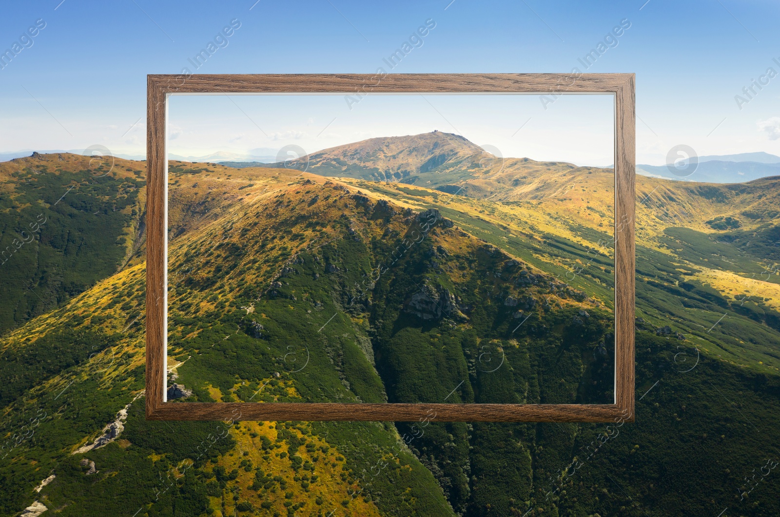 Image of Wooden frame and beautiful mountains under blue sky