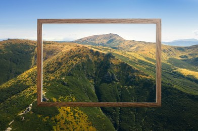 Image of Wooden frame and beautiful mountains under blue sky