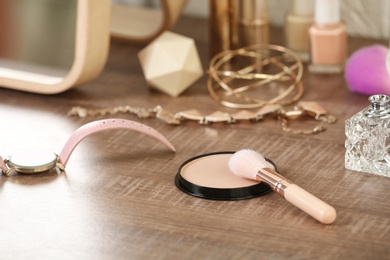 Photo of Face powder with brush and accessories on dressing table