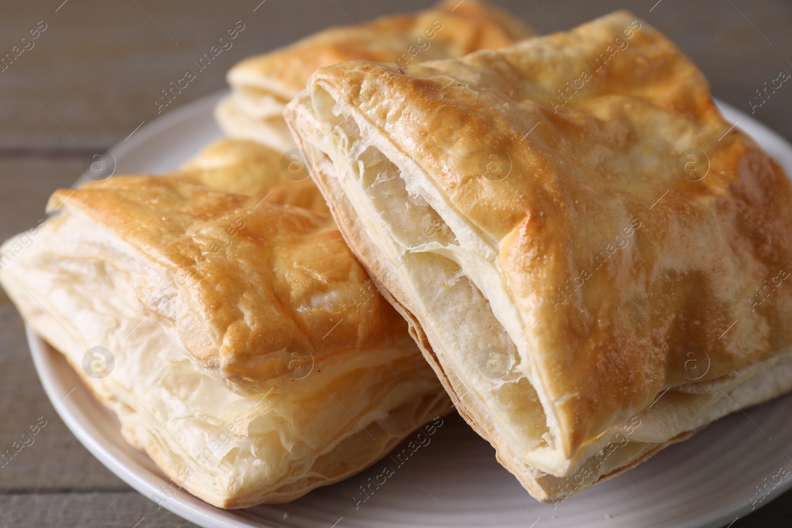 Photo of Delicious fresh puff pastries on table, closeup