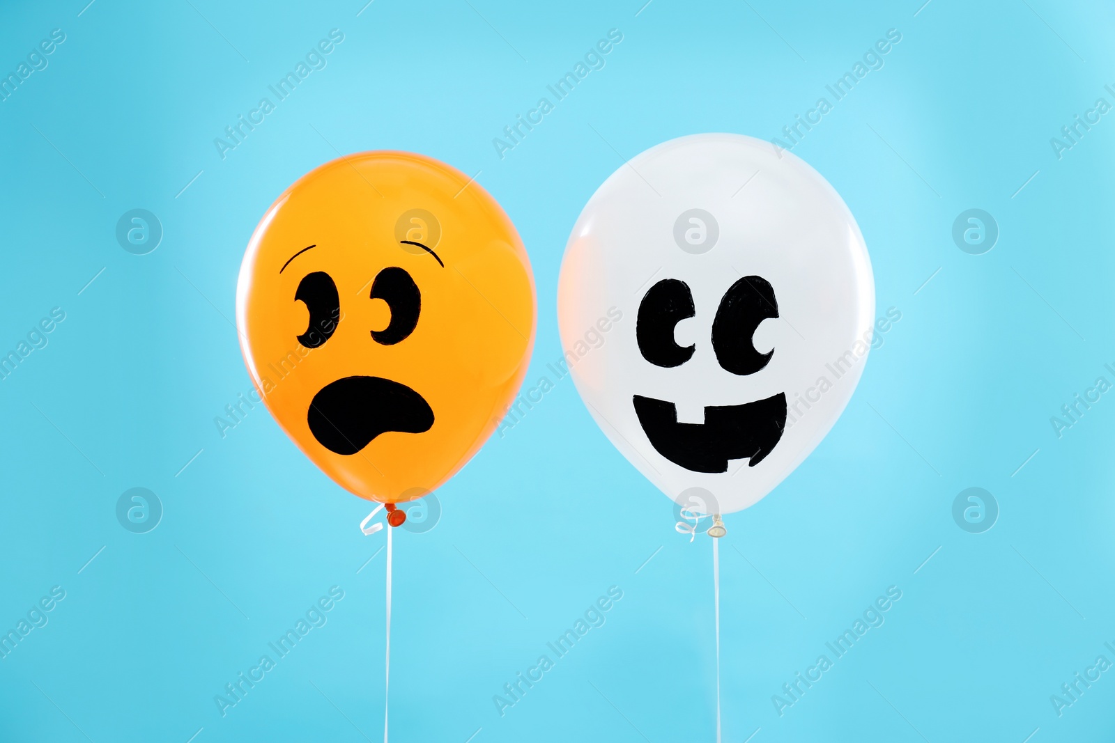 Photo of Colorful balloons for Halloween party on blue background