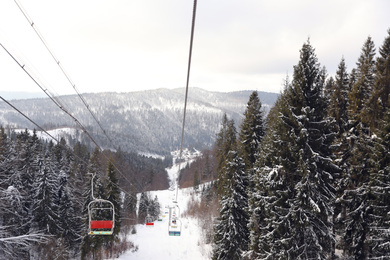 Photo of Picturesque mountain landscape with snowy forest in winter, view from ski lift