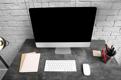 Photo of Comfortable workplace with computer on desk in home office