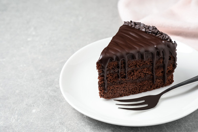 Delicious chocolate cake on light grey table