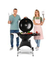 Happy couple cooking on barbecue grill, white background