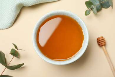 Photo of Flat lay composition with organic honey on beige background