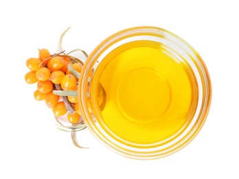 Photo of Natural sea buckthorn oil and fresh berries on white background, top view