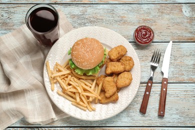 Photo of Delicious fast food menu on white wooden table, flat lay