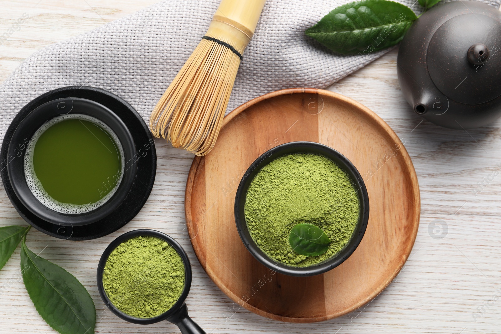 Photo of Flat lay composition with green matcha powder on white wooden table