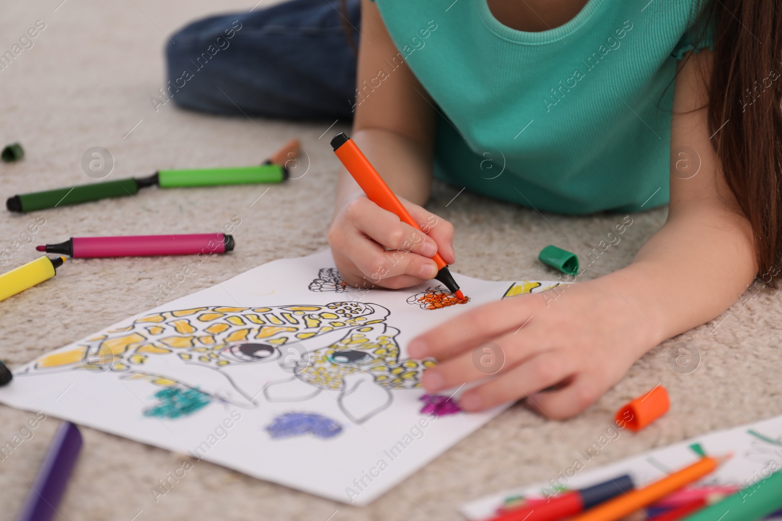 Photo of Child coloring drawing on floor at home, closeup