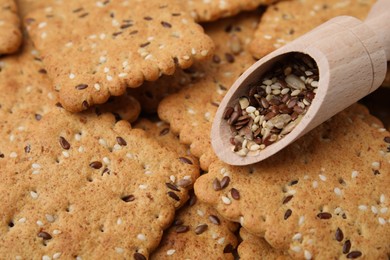 Photo of Scoop with grains on cereal crackers with flax and sesame seeds, closeup