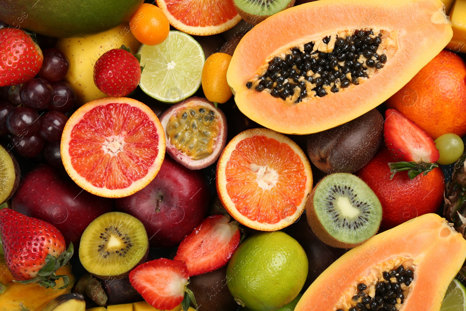 Photo of Many different delicious exotic fruits as background, top view