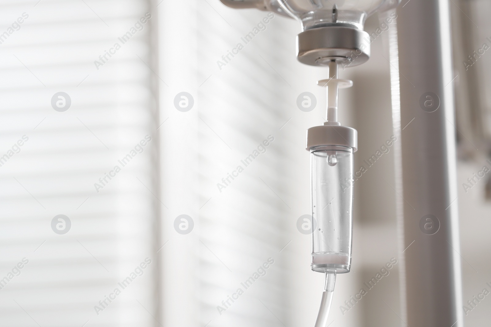 Photo of IV drip against blurred background, space for text