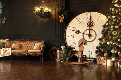 Stylish room interior with Christmas tree, big vintage clock and festive decor