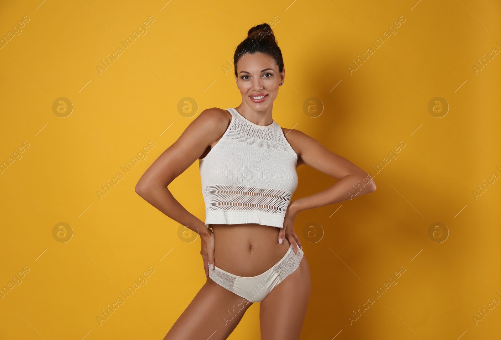 Photo of Beautiful woman in white sexy panties on yellow background