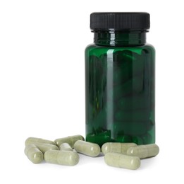 Photo of Bottle and pile of vitamin pills isolated on white