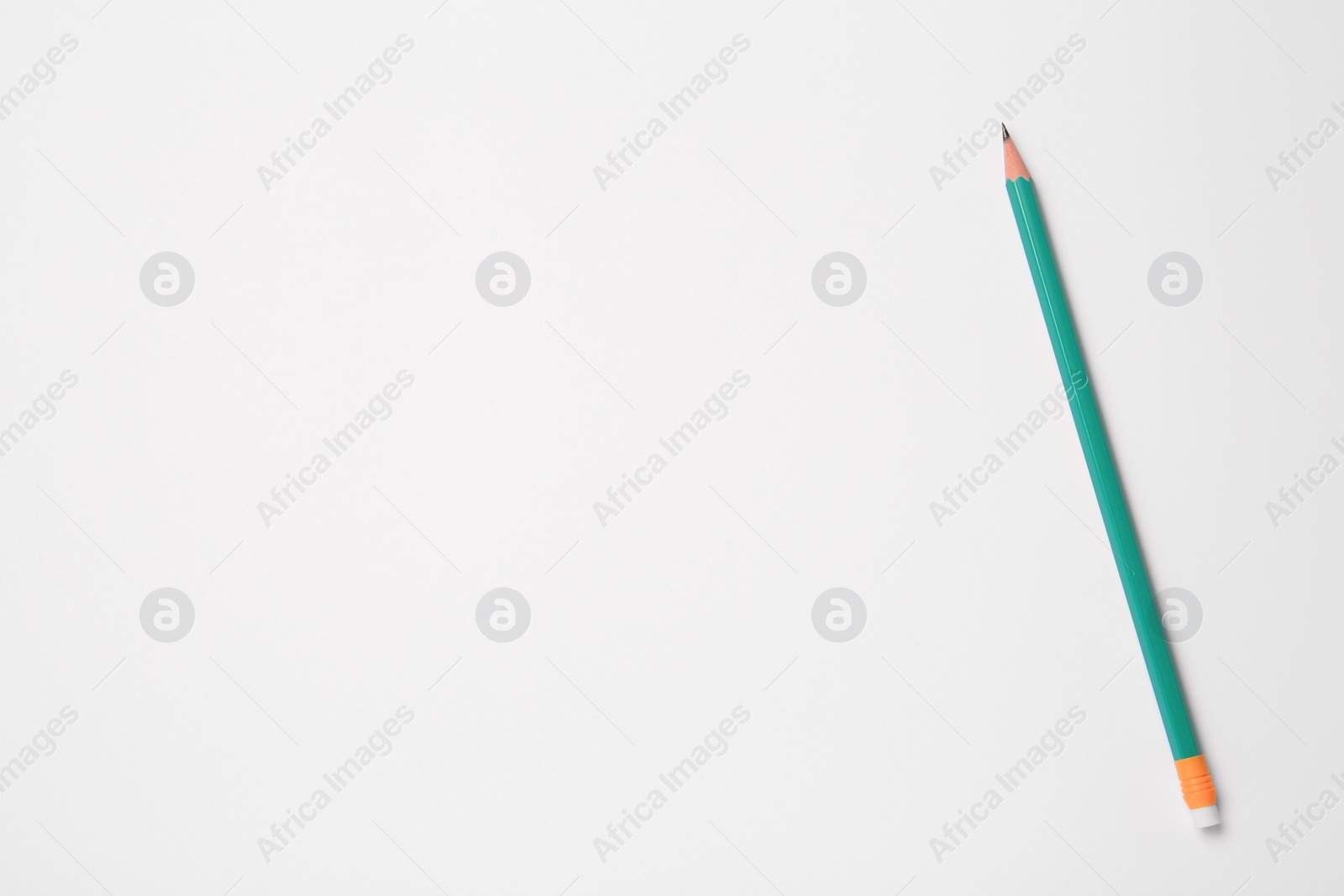 Photo of Sharp graphite pencil on white background, top view. Space for text