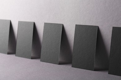 Photo of Blank black business cards on grey background. Mockup for design