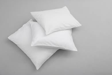 Photo of Clean soft bed pillows on grey background, top view