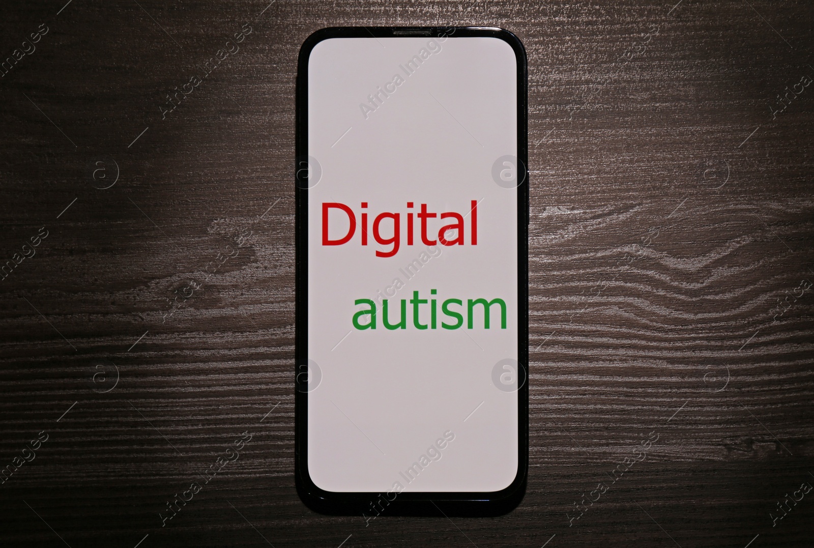 Photo of Smartphone with phrase Digital Autism on wooden table, top view. Addictive behavior