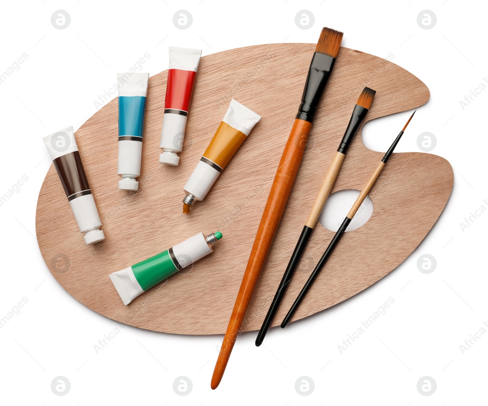 Photo of Wooden palette with oil paints and brushes on white background, top view