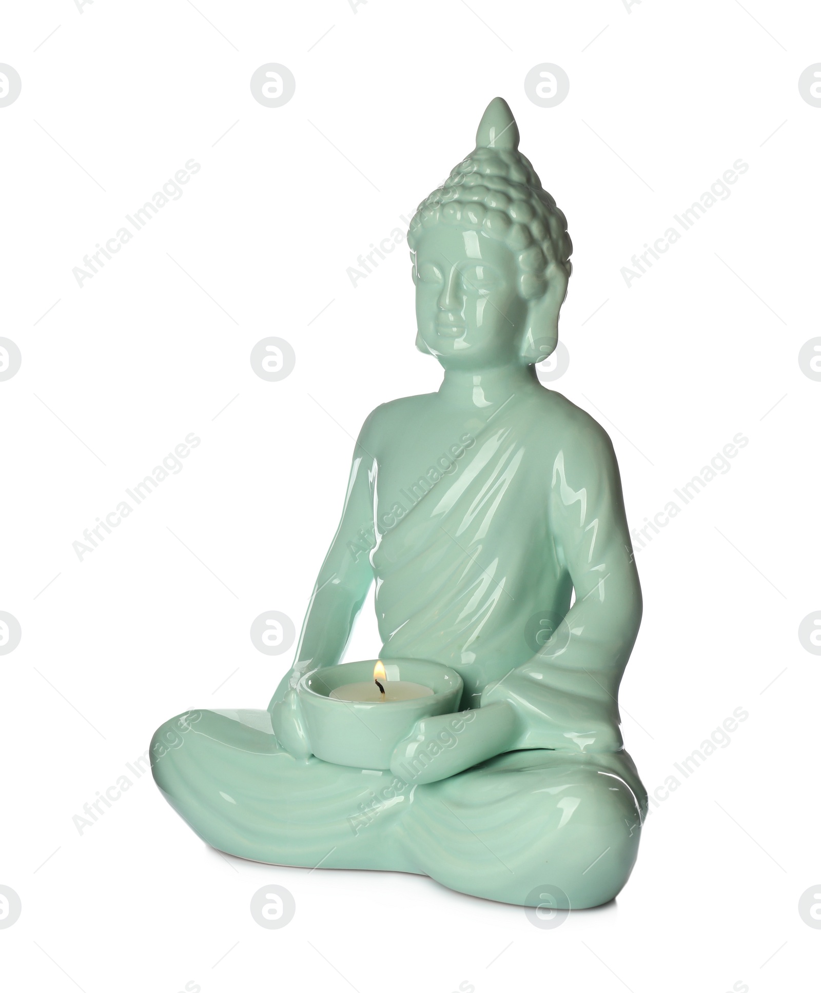 Photo of Beautiful ceramic Buddha sculpture with burning candle isolated on white